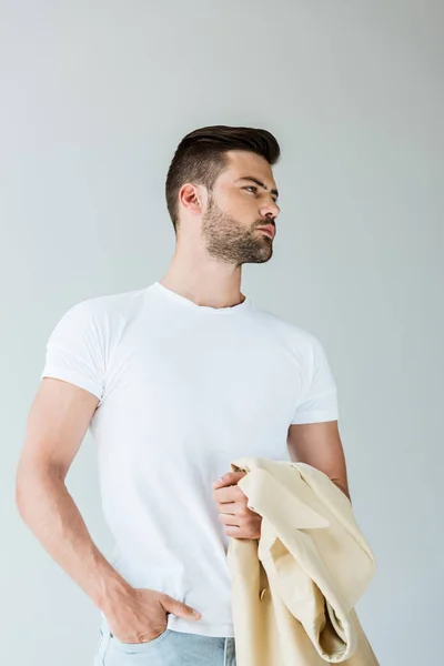 Fashionable confident man holding his jacket on arm isolated on white background — Stock Photo
