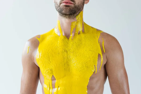 Bearded man covered with yellow paint isolated on white background — Stock Photo