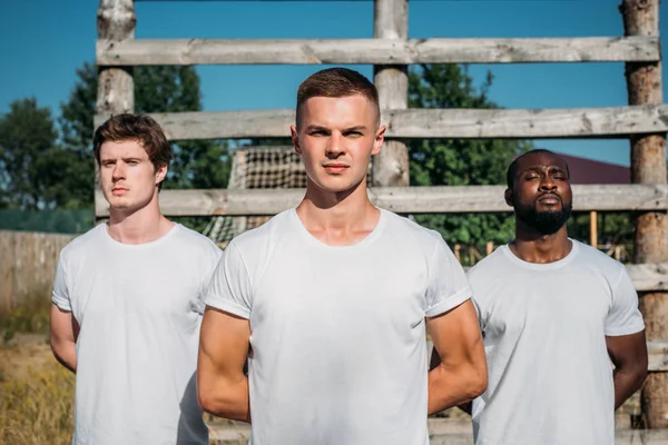 Portrait of interracial young soldiers in white shirts on range — Stock Photo