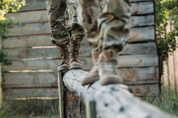 Abgeschnittene Aufnahme von Soldaten in Militäruniform, die Hindernislauf auf der Schießanlage üben — Stockfoto