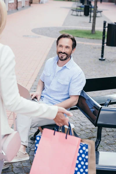 Cropped image of couple meeting after shopping on street — Stock Photo