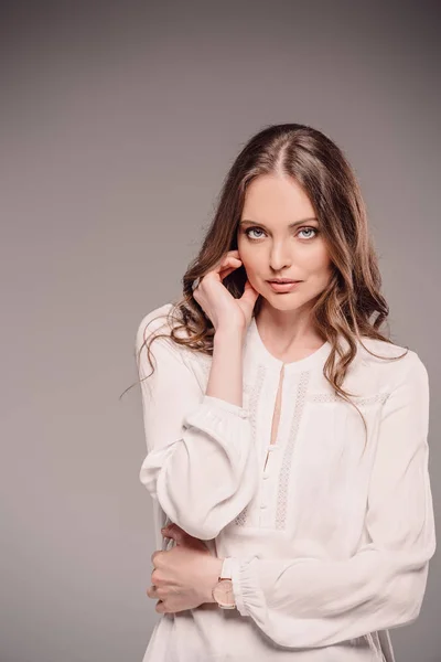 Modelo femenino elegante posando aislado sobre fondo gris - foto de stock