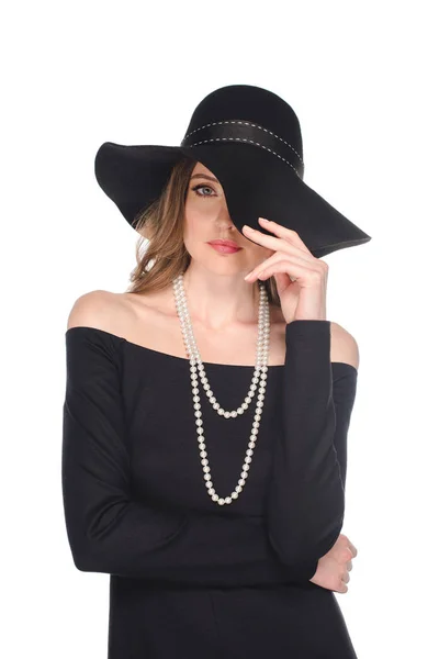 Elegant female model in black straw posing isolated on white background — Stock Photo