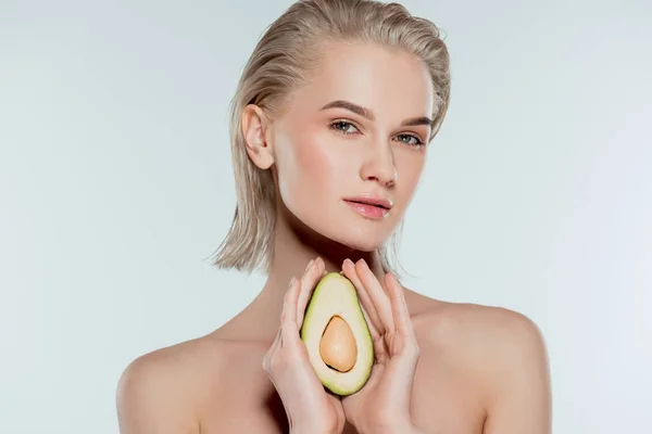 Beautiful girl posing with avocado, isolated on grey — Stock Photo