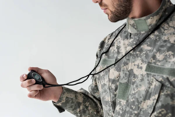 Partial view of soldier in military uniform with stop watch isolated on grey — Stock Photo