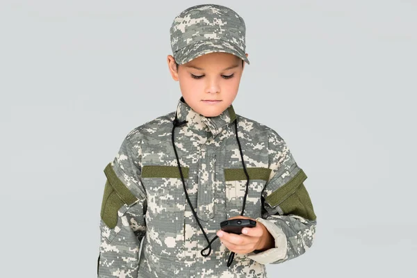 Portrait of kid in military uniform with stop watch in hand isolated on grey — Stock Photo
