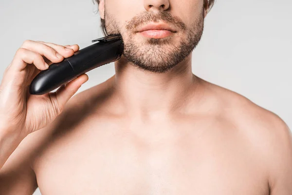 Partial view of man with electric clipper isolated on grey — Stock Photo