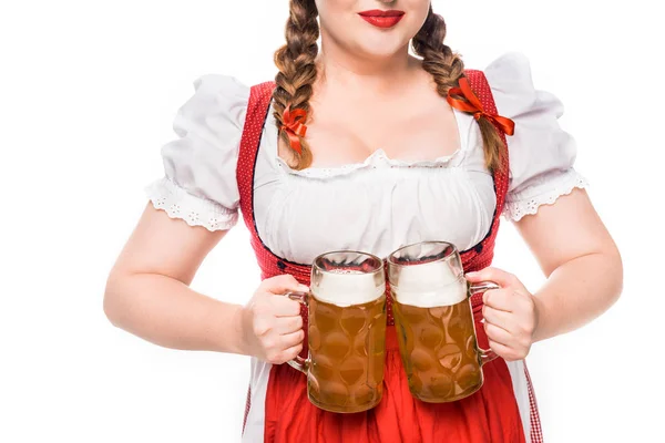 Cropped image of oktoberfest waitress in traditional bavarian dress showing mugs of light beer isolated on white background — Stock Photo
