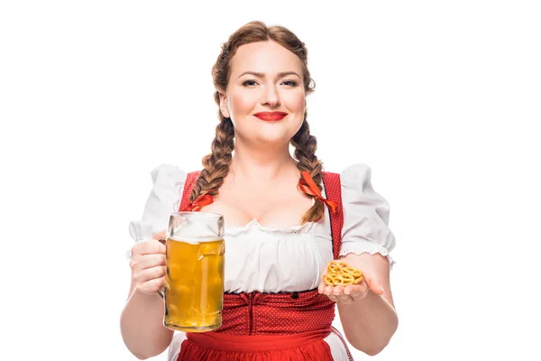 Oktoberfest waitress in traditional german dress holding little pretzels and mug of light beer isolated on white background — Stock Photo