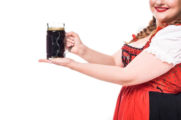 Cropped image of oktoberfest waitress in traditional bavarian dress holding mug of dark beer isolated on white background — Stock Photo