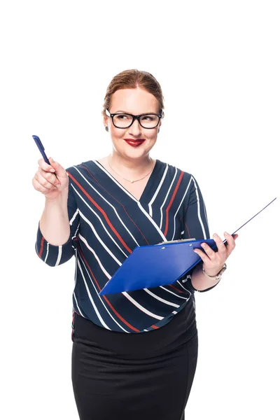 Smiling businesswoman in eyeglasses with clipboard pointing by pen isolated on white background — Stock Photo