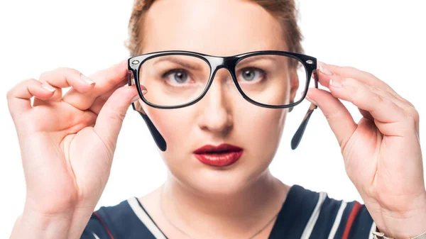 Focused businesswoman looking at eyeglasses isolated on white background — Stock Photo