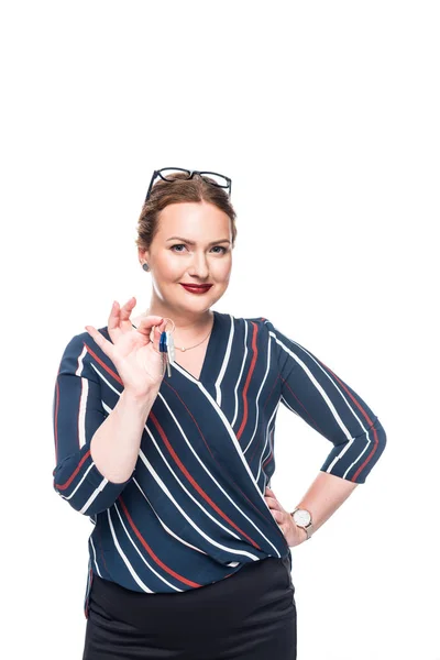 Happy female estate agent showing keys from house isolated on white background — Stock Photo