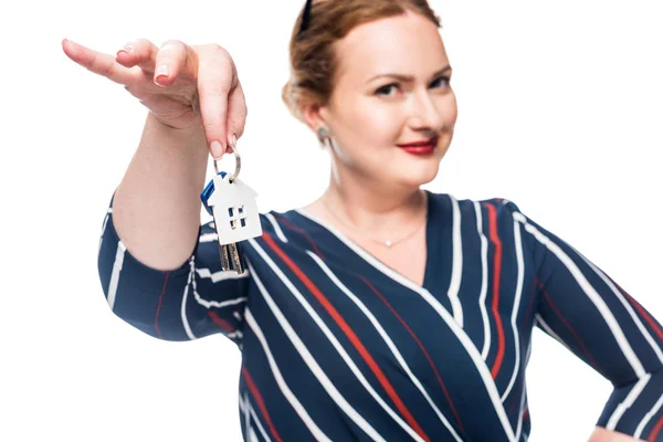 Selective focus of female realtor showing keys from house isolated on white background — Stock Photo