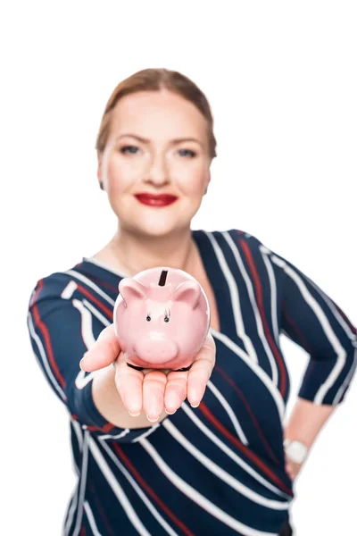 Selective focus of businesswoman showing pink piggy bank isolated on white background — Stock Photo