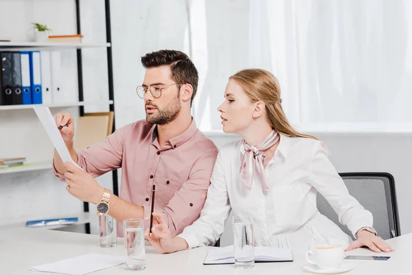 Confident business colleagues doing paperwork together at modern office — Stock Photo