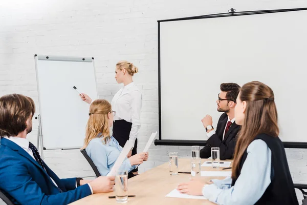 Team of business people listening to conference of their colleague — Stock Photo