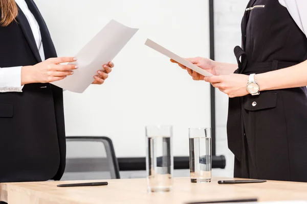 Cropped shot of businesswomen with documents at modern office — Stock Photo