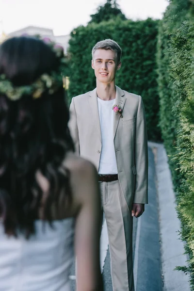 Selective focus of happy handsome groom looking at bride — Stock Photo