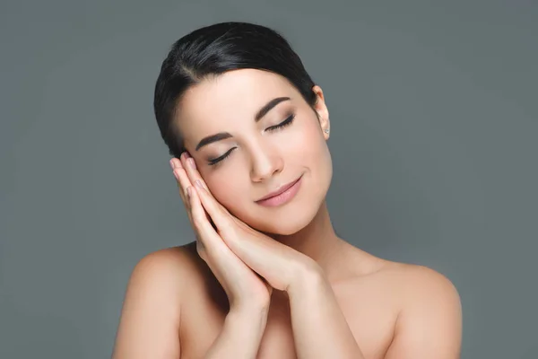 Portrait of young attractive woman with eyes closed isolated on grey — Stock Photo