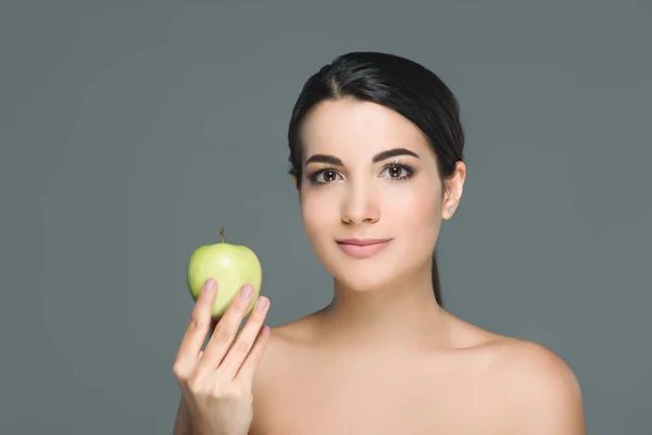 Portrait of young woman with fresh apple isolated on grey — Stock Photo