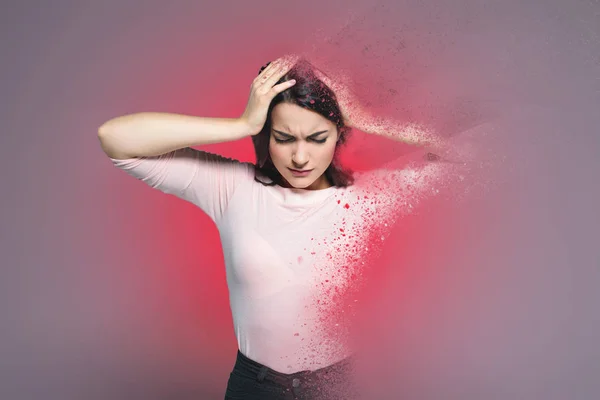 Beautiful woman suffering from headache, with red splatter around — Stock Photo