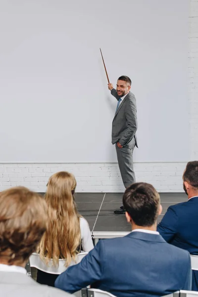 Handsome business coach making presentation during training in hub — Stock Photo