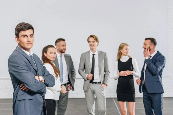 Young professional businesspeople standing in hub — Stock Photo