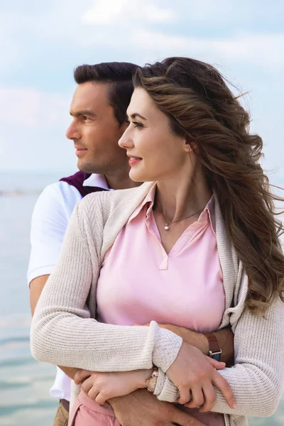 Portrait of beautiful romantic couple with river on background — Stock Photo