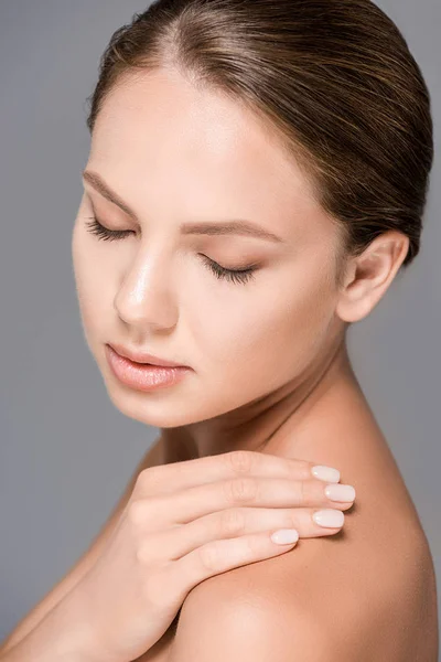 Portrait of beautiful woman with nude makeup isolated on grey — Stock Photo