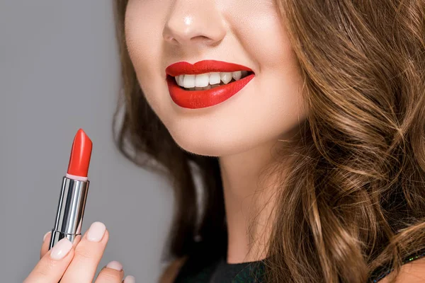 Partial view of smiling woman with red lipstick isolated on grey — Stock Photo