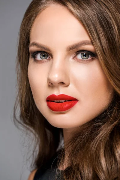 Portrait of attractive young woman with red lipstick on lips looking at camera — Stock Photo