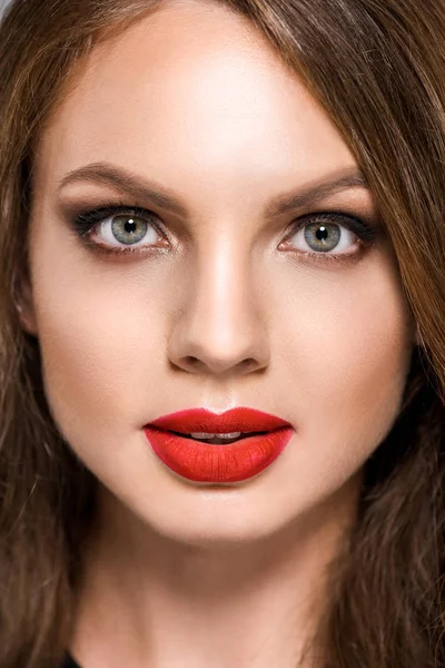 Portrait of attractive young woman with red lipstick on lips looking at camera — Stock Photo