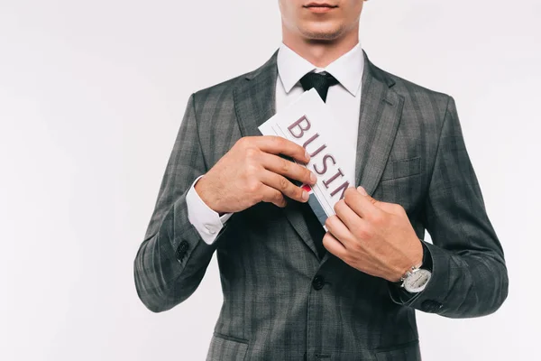 Imagen recortada de empresario poniendo periódico en el bolsillo de la chaqueta aislado en blanco - foto de stock