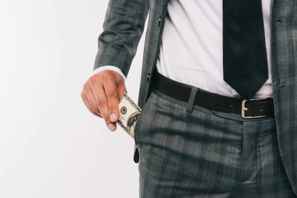 Обрізане зображення бізнесмена, який бере долар з кишені ізольовано на білому — стокове фото