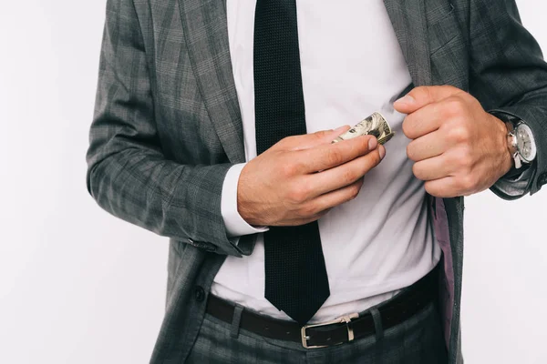 Обрізане зображення бізнесмена, що кладе гроші в кишеню куртки ізольовані на білому — стокове фото