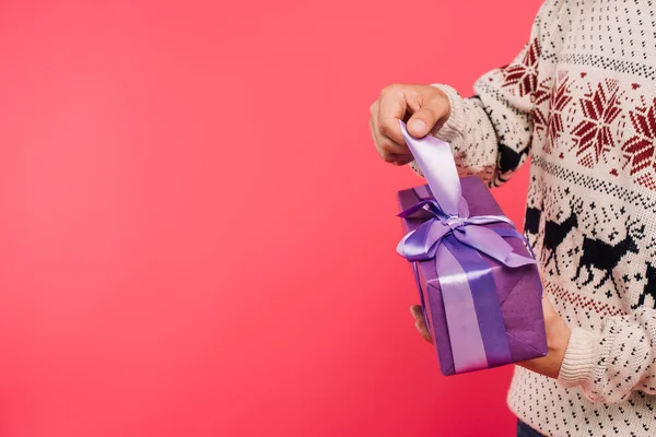 Cropped image of man opening present in violet box isolated on pink — Stock Photo