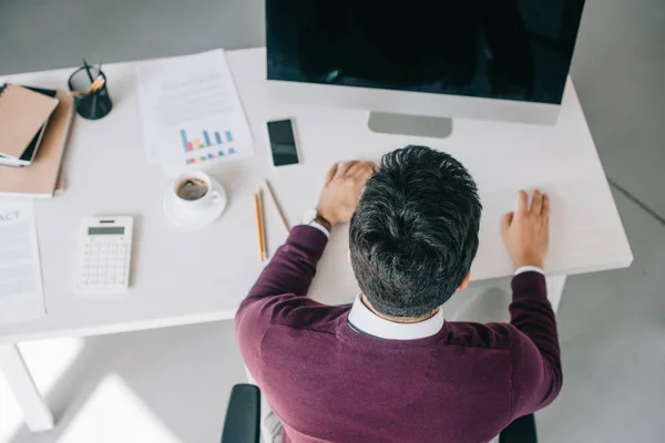 High angle view of designer in burgundy sweater using computer in office — Stock Photo