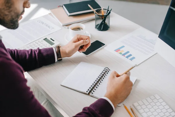 Cropped image of designer making sketch in notebook in office — Stock Photo