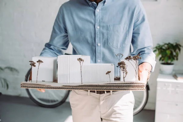 Cropped image of architect holding architecture model in office — Stock Photo