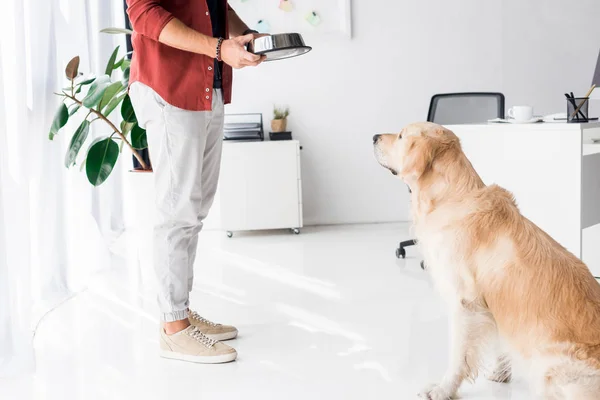 Cropped view of man taking selfie on smartphone with golden retriever dog — Stock Photo