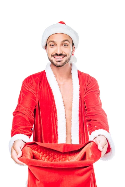 Happy young man in santa claus costume with christmas sack isolated on white background — Stock Photo