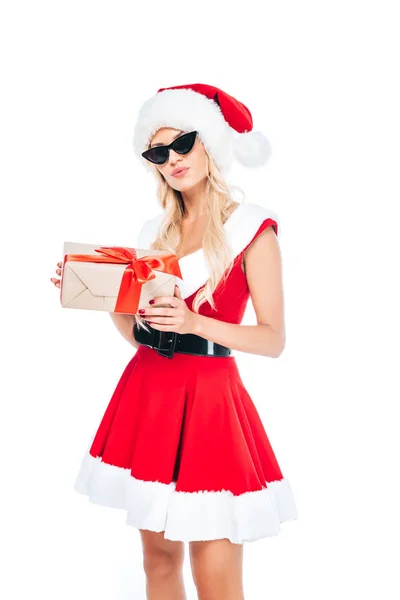 Young santa girl in sunglasses holding gift box isolated on white background — Stock Photo