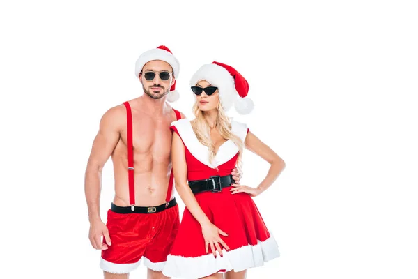 Couple confiant dans des chapeaux de Noël et des lunettes de soleil debout isolé sur fond blanc — Photo de stock