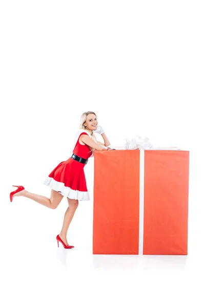Sexy santa girl in christmas dress standing with big gift box isolated on white background — Stock Photo