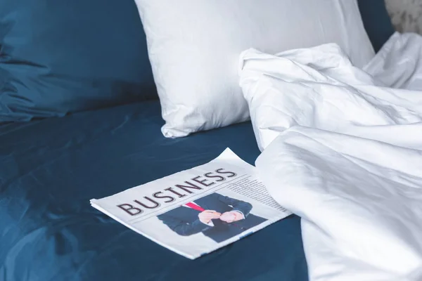 Close-up shot of business newspaper lying on bed — Stock Photo