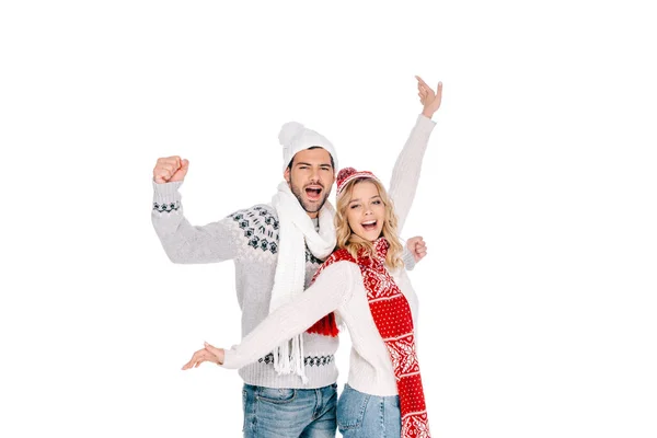 Feliz jovem casal em camisolas e chapéus sorrindo para a câmera isolada no branco — Fotografia de Stock