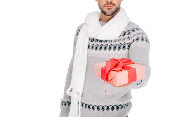 Cropped shot of man in sweater and scarf holding gift box isolated on white — Stock Photo