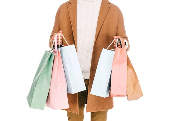 Mid section of young man holding paper bags isolated on white — Stock Photo