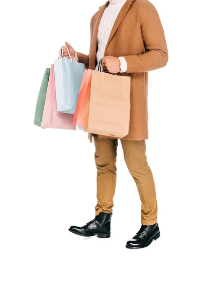 Cropped shot of young man holding shopping bags isolated on white — Stock Photo